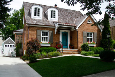 Example of a classic two-story brick exterior home design in Chicago