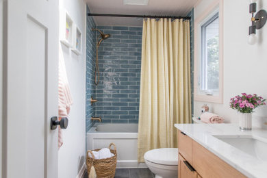Inspiration for a small transitional master blue tile and porcelain tile porcelain tile and gray floor bathroom remodel in Toronto with flat-panel cabinets, light wood cabinets, a two-piece toilet, white walls, an undermount sink, quartzite countertops and white countertops