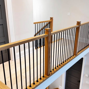 Modern White Oak Open Riser Staircase with Black Metal Balusters