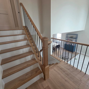 Metal and Wood Indoor Railing Installation with Red Oak T-Rail & Black Balusters
