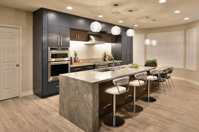 Inspiration for a large transitional porcelain tile and beige floor eat-in kitchen remodel in Phoenix with an undermount sink, flat-panel cabinets, blue cabinets, quartz countertops, white backsplash, porcelain backsplash, stainless steel appliances and an island