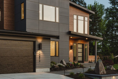 Imagen de fachada de casa gris minimalista grande de dos plantas con tejado de un solo tendido, revestimiento de aglomerado de cemento y tejado de teja de madera