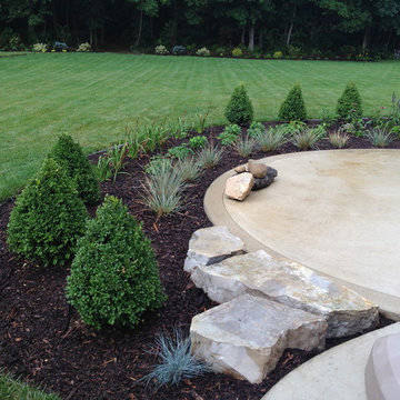 Curvilinear planting bed design complements patio