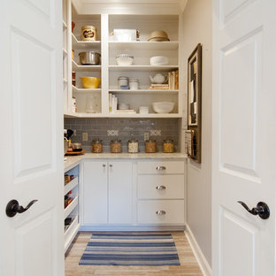 Transitional kitchen pantry pictures - Transitional porcelain floor kitchen pantry photo in New Orleans with quartz countertops, gray backsplash, flat-panel cabinets, white cabinets and no island