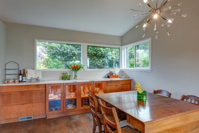 Mid-sized 1960s vinyl floor, brown floor and vaulted ceiling great room photo in Seattle with gray walls