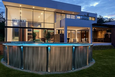 Example of a small minimalist backyard round aboveground pool design in Montreal