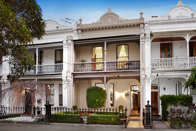 Inspiration for a traditional two-storey brick beige exterior in Melbourne.