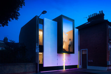 This is an example of a mid-sized contemporary three-storey stucco white exterior in London.
