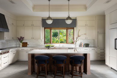 Kitchen - transitional porcelain tile and gray floor kitchen idea in San Diego with beaded inset cabinets, white cabinets, quartzite countertops, ceramic backsplash, stainless steel appliances and an island
