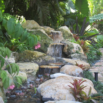 Tropical backyard waterfall and pond