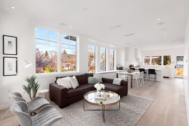 Mid-sized contemporary open concept living room in Vancouver with light hardwood floors.
