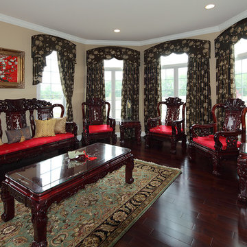 Asian sitting room with arched windows and traditional rosewood furniture