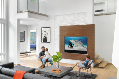 Large contemporary open concept family room in St Louis with white walls and a built-in media wall.