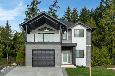 Inspiration for a mid-sized craftsman black two-story concrete fiberboard exterior home remodel in Other with a black roof
