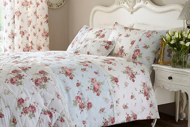 Example of a mid-sized cottage chic master medium tone wood floor bedroom design in Madrid with beige walls