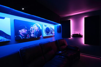 Photo of a small modern enclosed home theatre in Perth with grey walls, carpet and a projector screen.