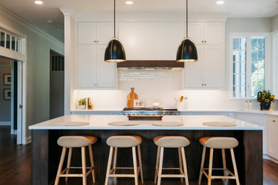 Inspiration for a large timeless l-shaped medium tone wood floor and brown floor eat-in kitchen remodel in Baltimore with an undermount sink, beaded inset cabinets, dark wood cabinets, quartz countertops, white backsplash, porcelain backsplash, stainless steel appliances, an island and white countertops