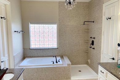 Example of a large classic master beige tile and ceramic tile mosaic tile floor, beige floor and tray ceiling bathroom design in San Francisco with beige walls, granite countertops and brown countertops