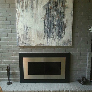 Bild på ett mellanstort funkis allrum med öppen planlösning, med ett finrum, grå väggar, ljust trägolv, en standard öppen spis och en spiselkrans i tegelsten