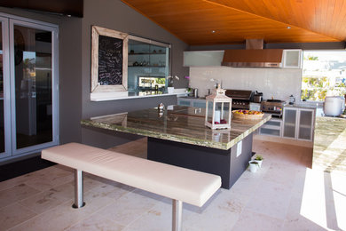 Photo of a mid-sized contemporary deck in Brisbane with an outdoor kitchen and a roof extension.