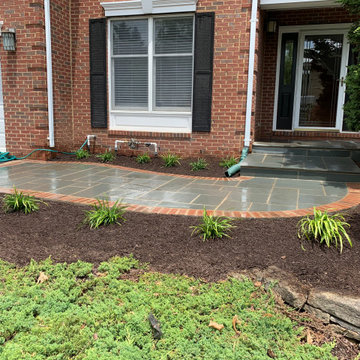 Limestone walkway with brick ascent to match house