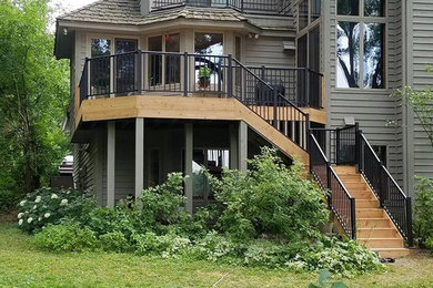 Example of a mid-sized classic backyard deck design in Other with no cover