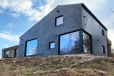 Brown contemporary house exterior in Manchester with a grey roof.