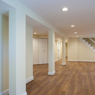 Inspiration for a large classic look-out basement in Chicago with beige walls and vinyl flooring.