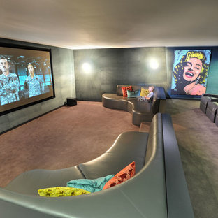 Home theater - large contemporary enclosed carpeted and gray floor home theater idea in Melbourne with gray walls and a projector screen