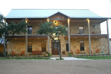 Farmhouse beige two-story stone exterior home idea in Austin