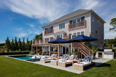 Inspiration for a large beach style backyard rectangular pool in New York with a hot tub and concrete slab.