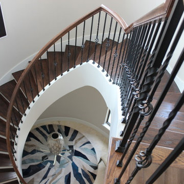 Curved Red Oak Stair with Single Basket & Twist Iron Balusters