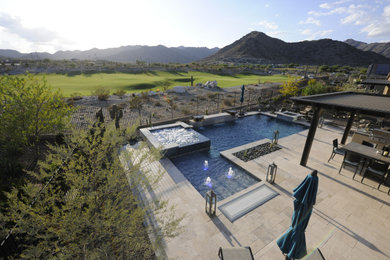 Mid-sized minimalist backyard stone and rectangular lap hot tub photo in Phoenix