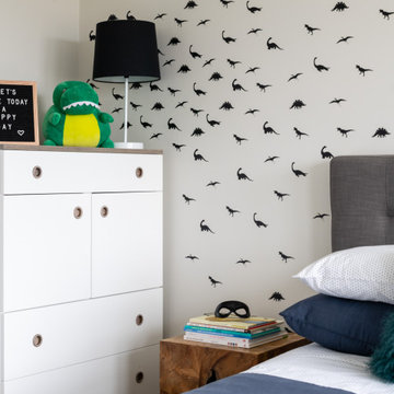 Kids’ Bedroom With White Dresser & Dinosaur Wall Feature