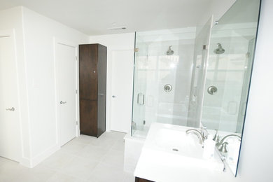 Inspiration for a contemporary gray tile and porcelain tile corner shower remodel in Dallas with an undermount sink, flat-panel cabinets, dark wood cabinets, quartz countertops and a two-piece toilet