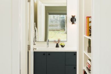 Inspiration for a scandinavian ceramic tile and beige floor bathroom remodel in Austin with flat-panel cabinets, blue cabinets, white walls, an undermount sink, quartz countertops and white countertops