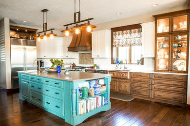 Large l-shaped eat-in kitchen in Indianapolis with a farmhouse sink, turquoise cabinets, quartzite benchtops, stainless steel appliances, with island and recessed-panel cabinets.