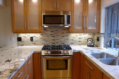 Example of a trendy u-shaped kitchen design in Salt Lake City with an undermount sink, granite countertops and stainless steel appliances