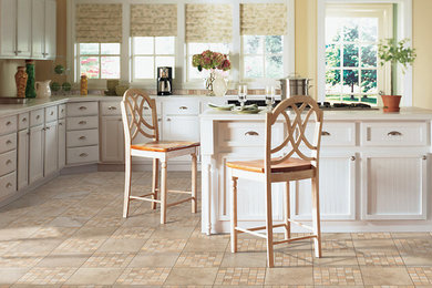 Eat-in kitchen - mid-sized traditional u-shaped ceramic tile and beige floor eat-in kitchen idea in Austin with raised-panel cabinets, white cabinets, quartz countertops, stainless steel appliances and an island