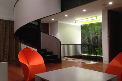 Inspiration for a modern dark wood floor family room remodel in New York with white walls