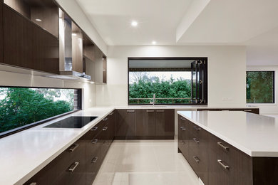 Mid-sized contemporary galley eat-in kitchen in Melbourne with ceramic floors, with island, beige floor and white benchtop.
