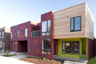 Inspiration for a contemporary two-storey apartment exterior in St Louis with mixed siding.