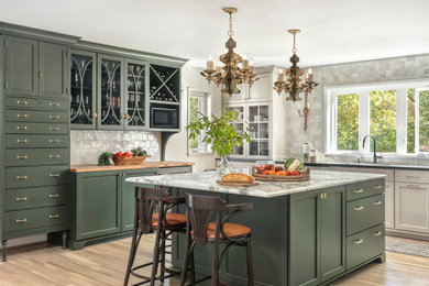 Large transitional u-shaped light wood floor and beige floor enclosed kitchen photo in St Louis with an undermount sink, shaker cabinets, green cabinets, marble countertops, white backsplash, terra-cotta backsplash, an island, white countertops and white appliances