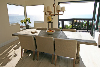 This is an example of a medium sized kitchen/dining room in London with white walls and ceramic flooring.