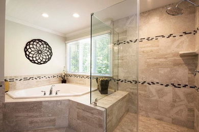 Inspiration for a large traditional master bathroom in Baltimore with recessed-panel cabinets, dark wood cabinets, a corner tub, a corner shower, beige tile, stone tile, beige walls, an undermount sink, marble benchtops, beige floor and an open shower.