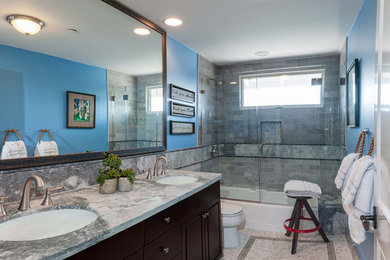 Mid-sized transitional 3/4 gray tile, white tile and stone tile mosaic tile floor and gray floor bathroom photo in San Diego with flat-panel cabinets, dark wood cabinets, a two-piece toilet, blue walls, an undermount sink, granite countertops and a hinged shower door