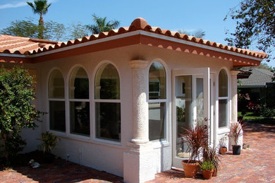 Example of a tuscan sunroom design in Tampa