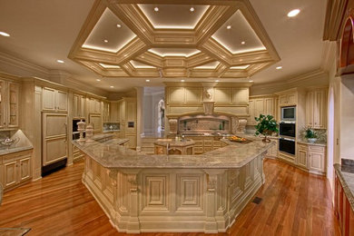 Inspiration for a huge timeless u-shaped kitchen pantry remodel in Charlotte with an undermount sink, raised-panel cabinets, white cabinets, granite countertops, paneled appliances and two islands