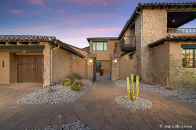 Inspiration for a large front xeriscape full sun garden in Phoenix with natural stone paving.