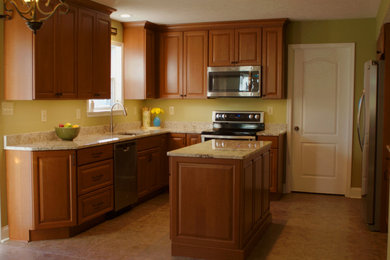 Mid-sized elegant u-shaped ceramic tile and beige floor eat-in kitchen photo in DC Metro with an undermount sink, raised-panel cabinets, medium tone wood cabinets, granite countertops, stainless steel appliances and an island